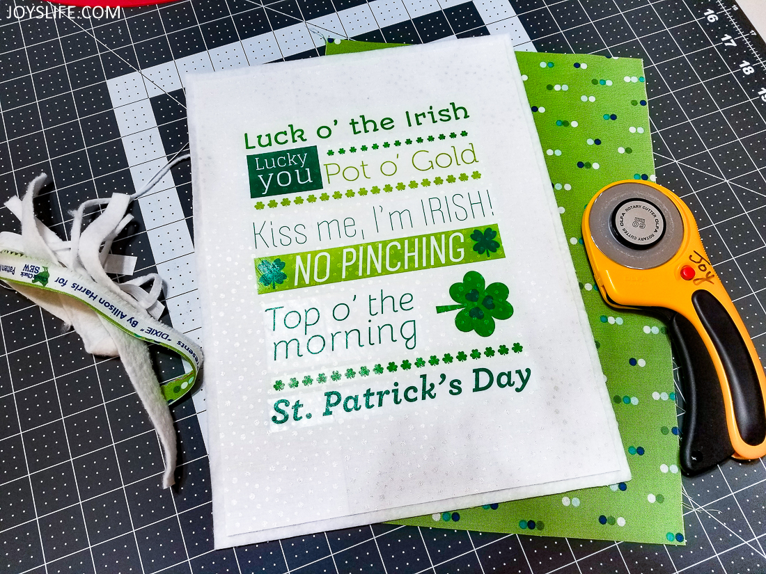 Trimming the fabric of a St. Patrick's Day wall hanging