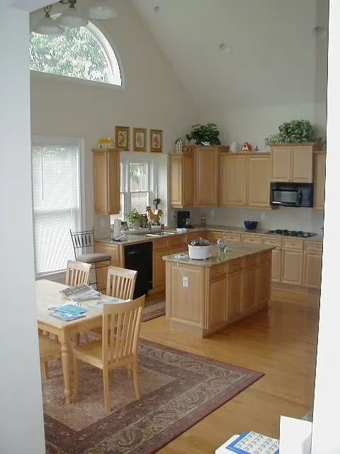 kitchen white walls tan cabinets wood floors