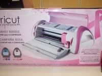 Pink Cricut Expression machine box with cartridge bundle and cutting designs.