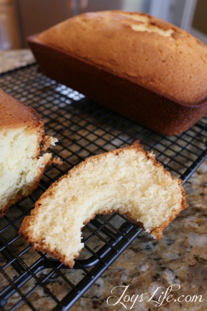 slice of vanilla pound cake showing soft buttery crumb on cooling rack joyslife.com