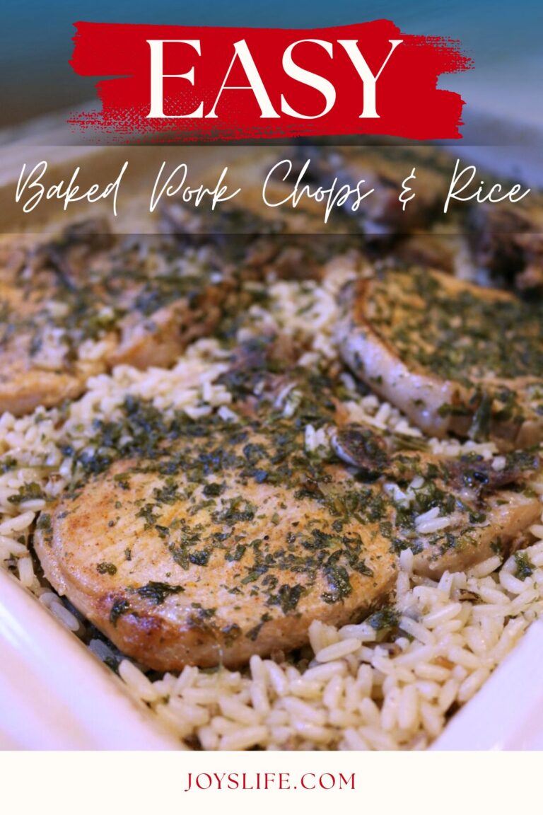 Baked pork chops with herbs served over white rice in a casserole dish – easy weeknight dinner recipe.