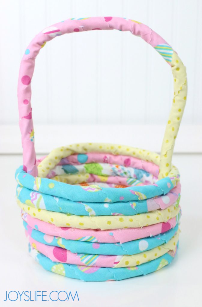 Handmade rope and fabric Easter basket in pastel colors, made with hot glue and cotton cord, perfect for DIY spring decor or personalized Easter gifts.