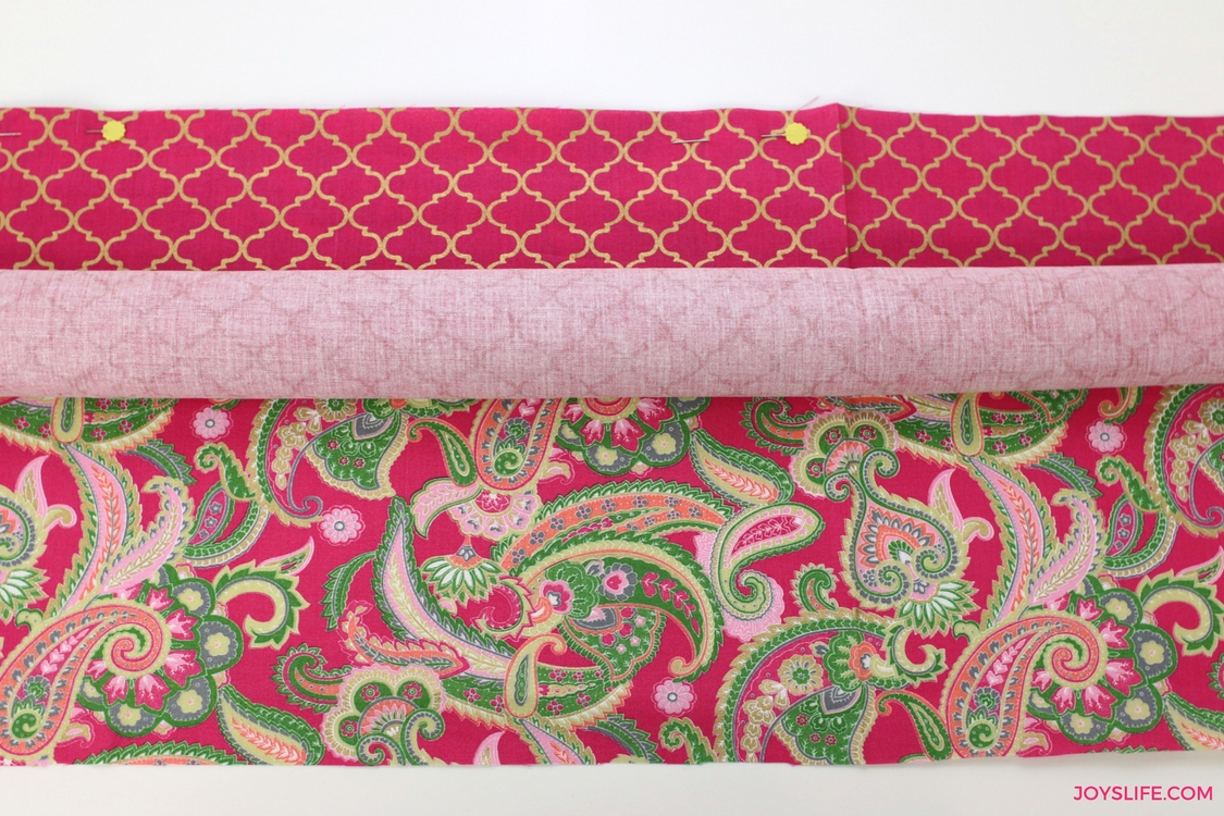 roll pink fabric pinned edges