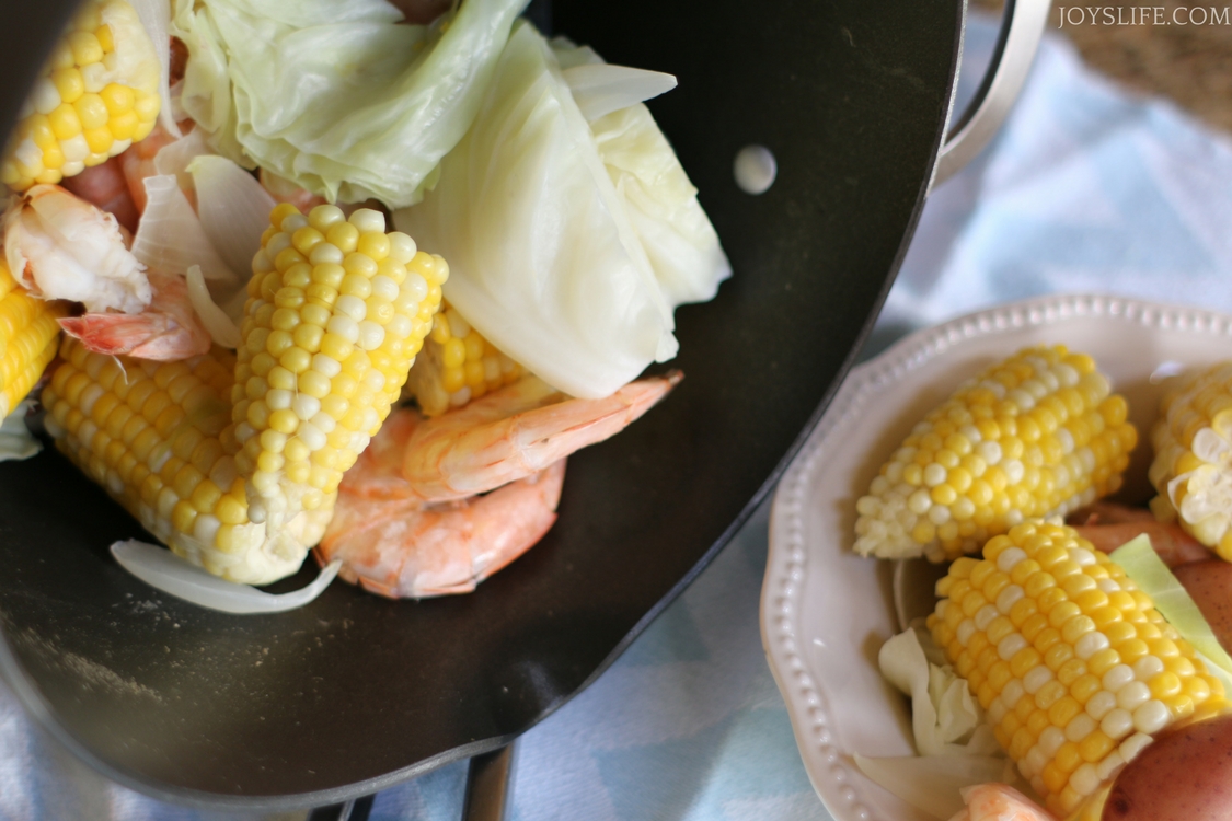 large pot of beer boiled shrimp and corn