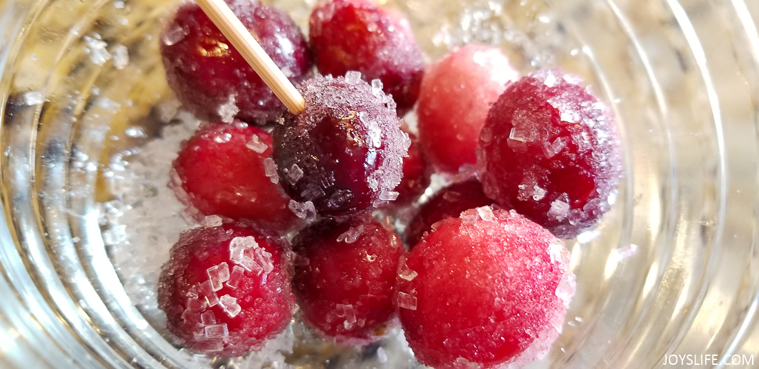 Cranberries coated in sugar crystals and granulated sugar