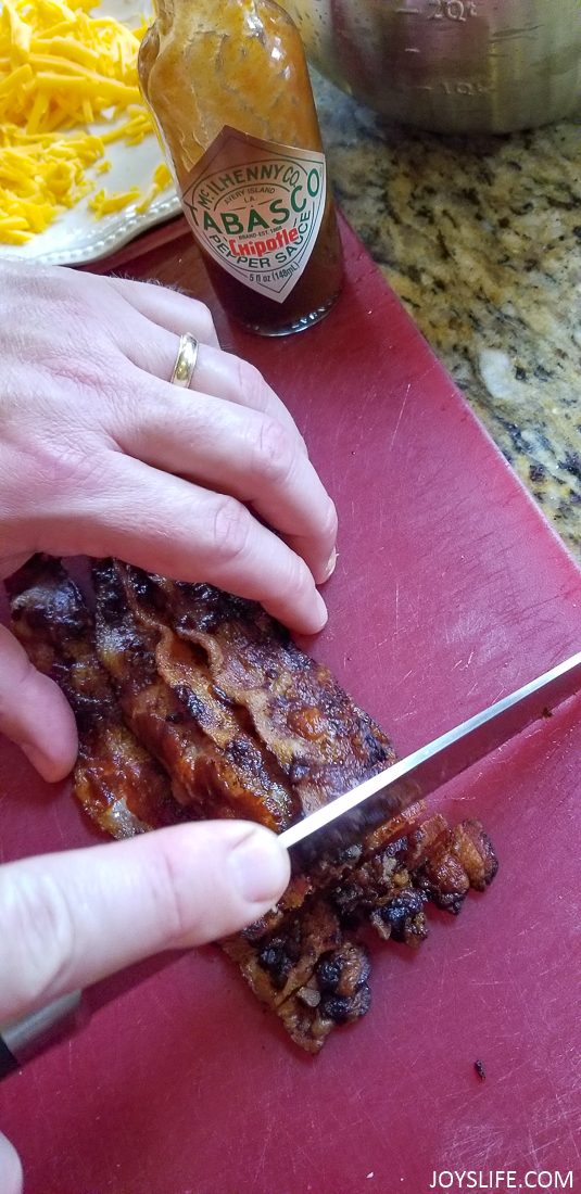 slicing Tabasco cooked bacon
