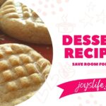 Peanut butter cookies with classic fork marks stacked on a red plate for Joy’s Life dessert recipes.