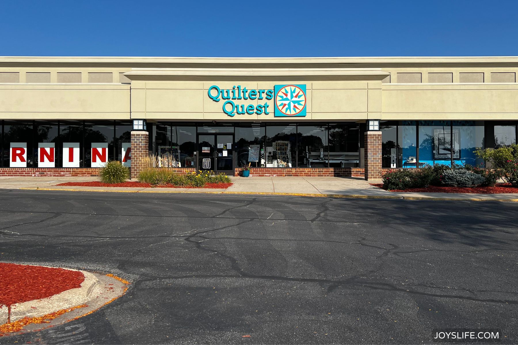 Quilter’s Quest quilt shop storefront in Downers Grove Illinois with signage and large glass windows. photo from JoysLife.com.