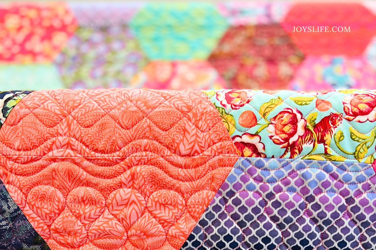 Close-up of Tula Pink hexagon quilt pieced and longarm quilted by Joy at joyslife.com on a Bernina Q24