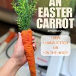 Hand holding a handmade fabric Easter carrot with faux greenery stem top in a sewing room workspace, tutorial at joyslife.com showing embroidery machine, sewing machine, or hand stitching methods