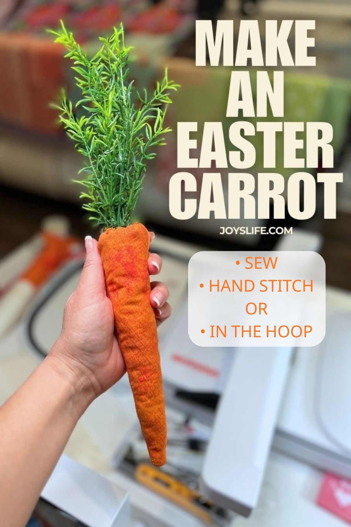 Hand holding a handmade fabric Easter carrot with faux greenery stem top in a sewing room workspace, tutorial at joyslife.com showing embroidery machine, sewing machine, or hand stitching methods